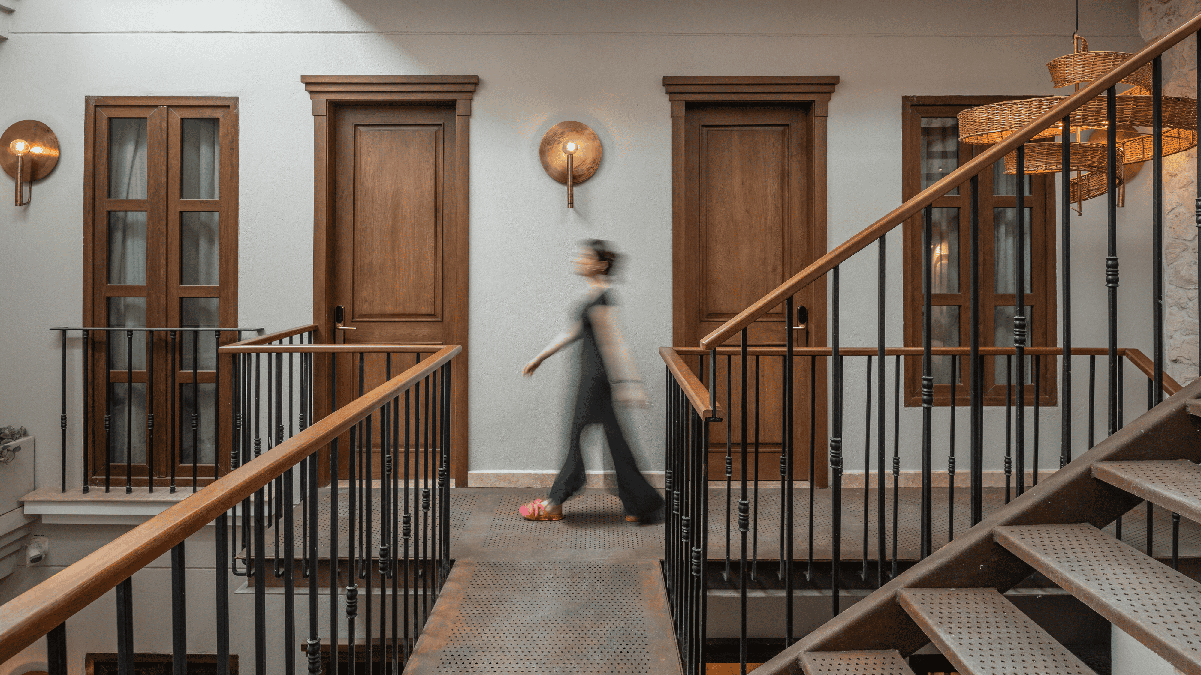 Elegant staircase with wooden handrails and warm lighting in a contemporary home setting.