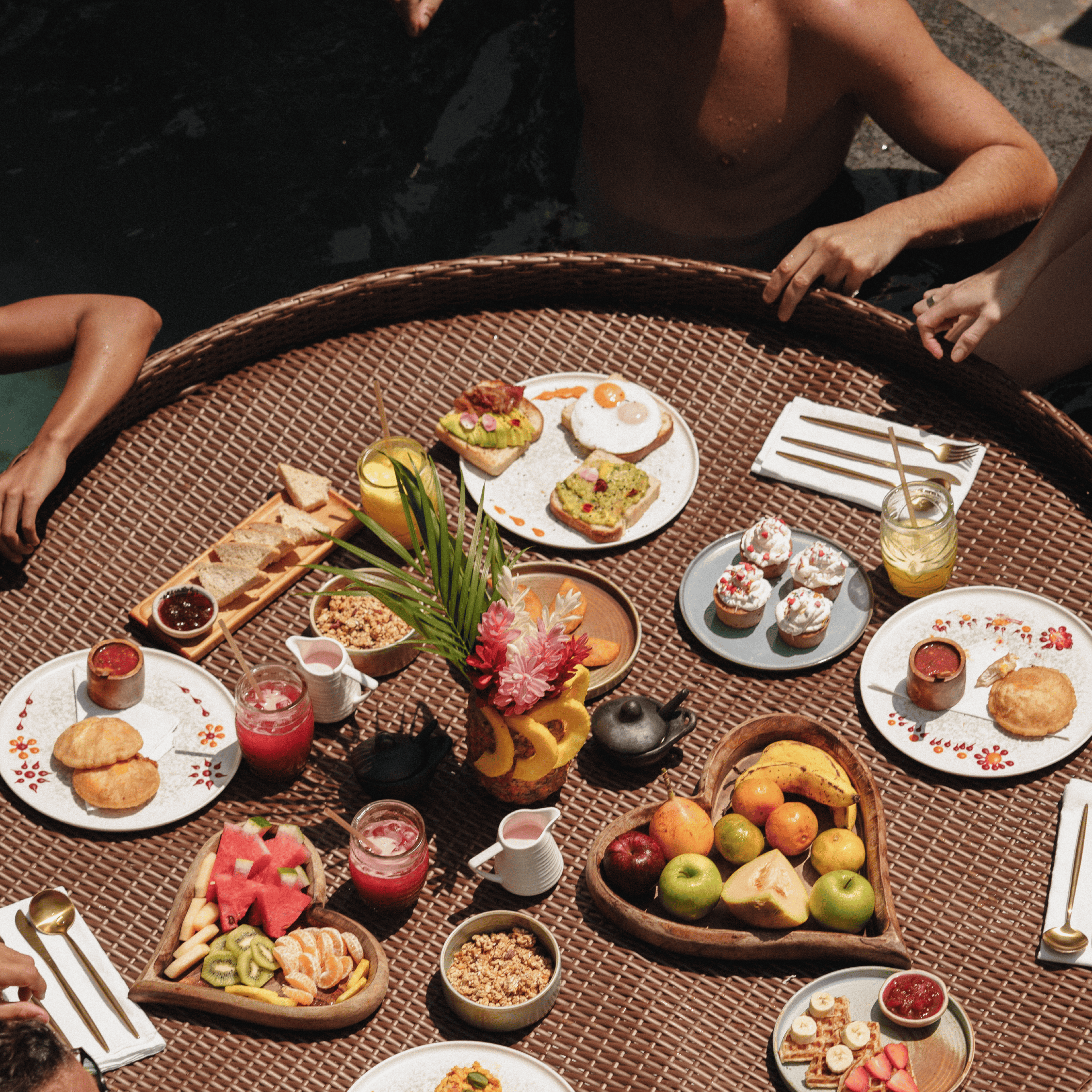 Luxurious poolside breakfast with fresh fruits, pastries, and beverages at Butiq World. Perfect for.