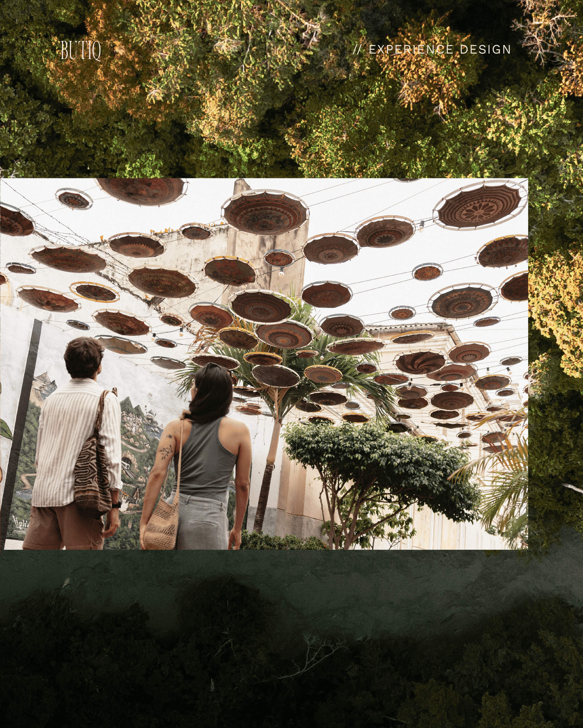 Outdoor art installation with circular sculptures and greenery at Butiq World.
