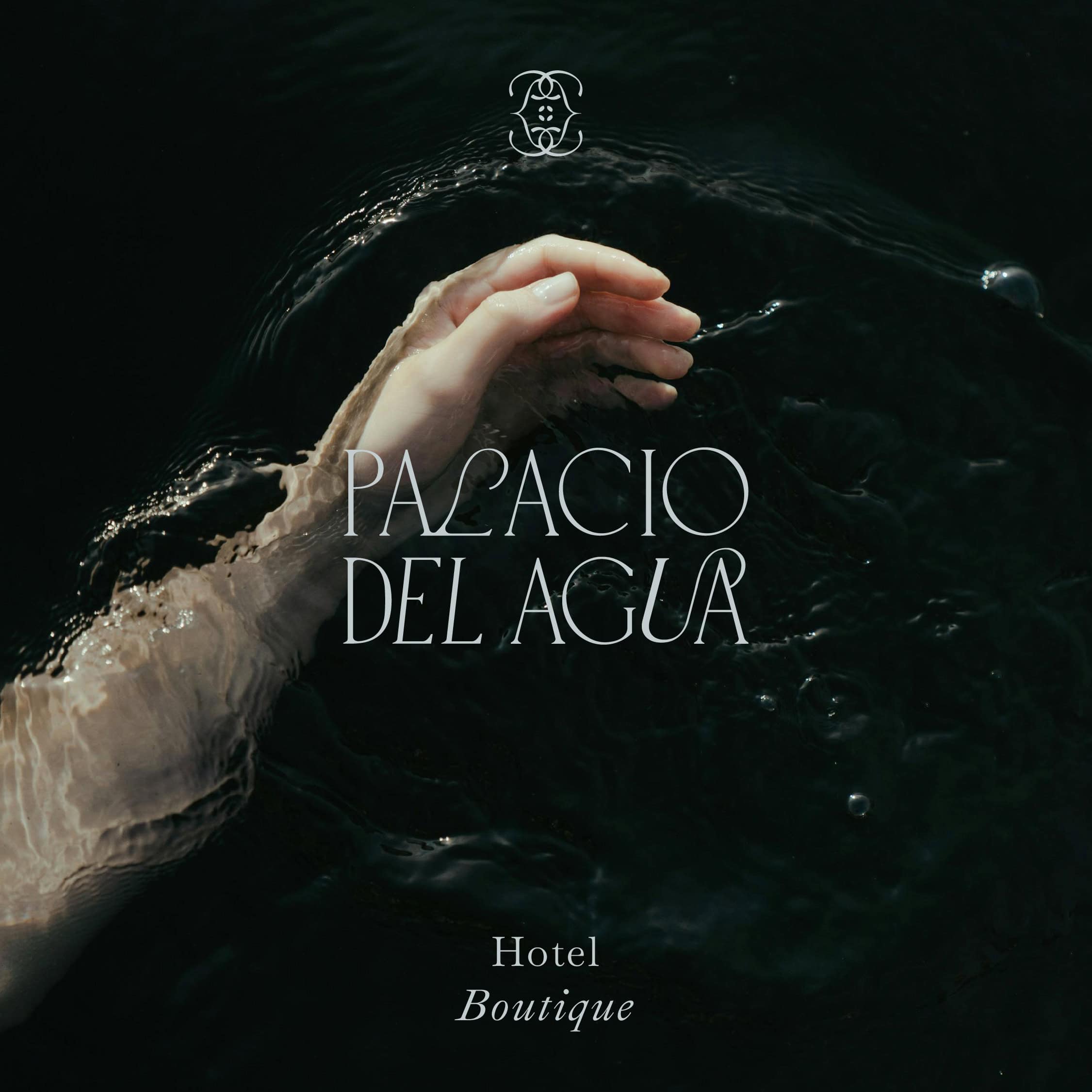 Elegant hand touching water at Palacio del Agua Hotel Boutique.