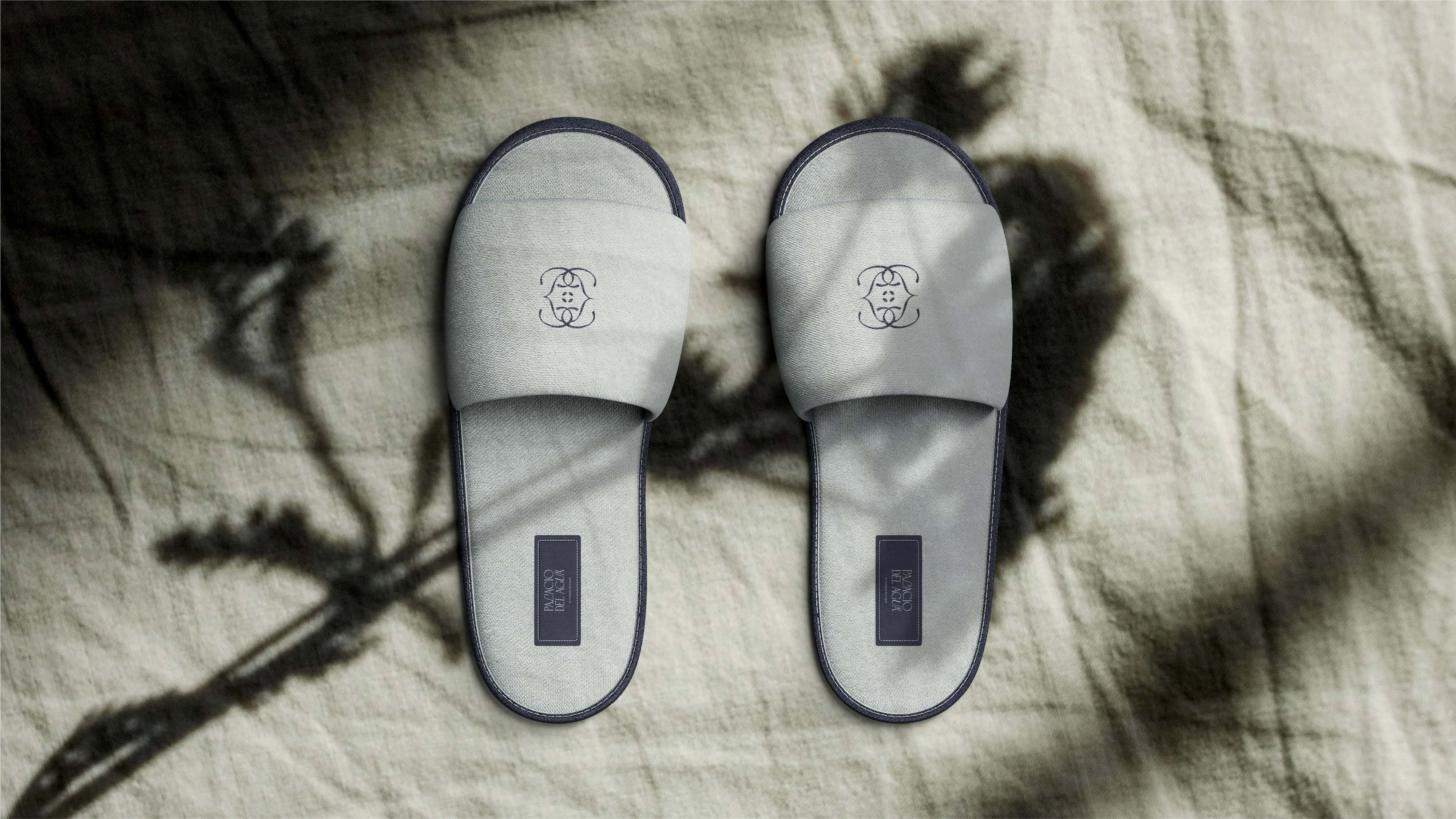 Minimalist white slides with black accents and logo, perfect for casual wear.