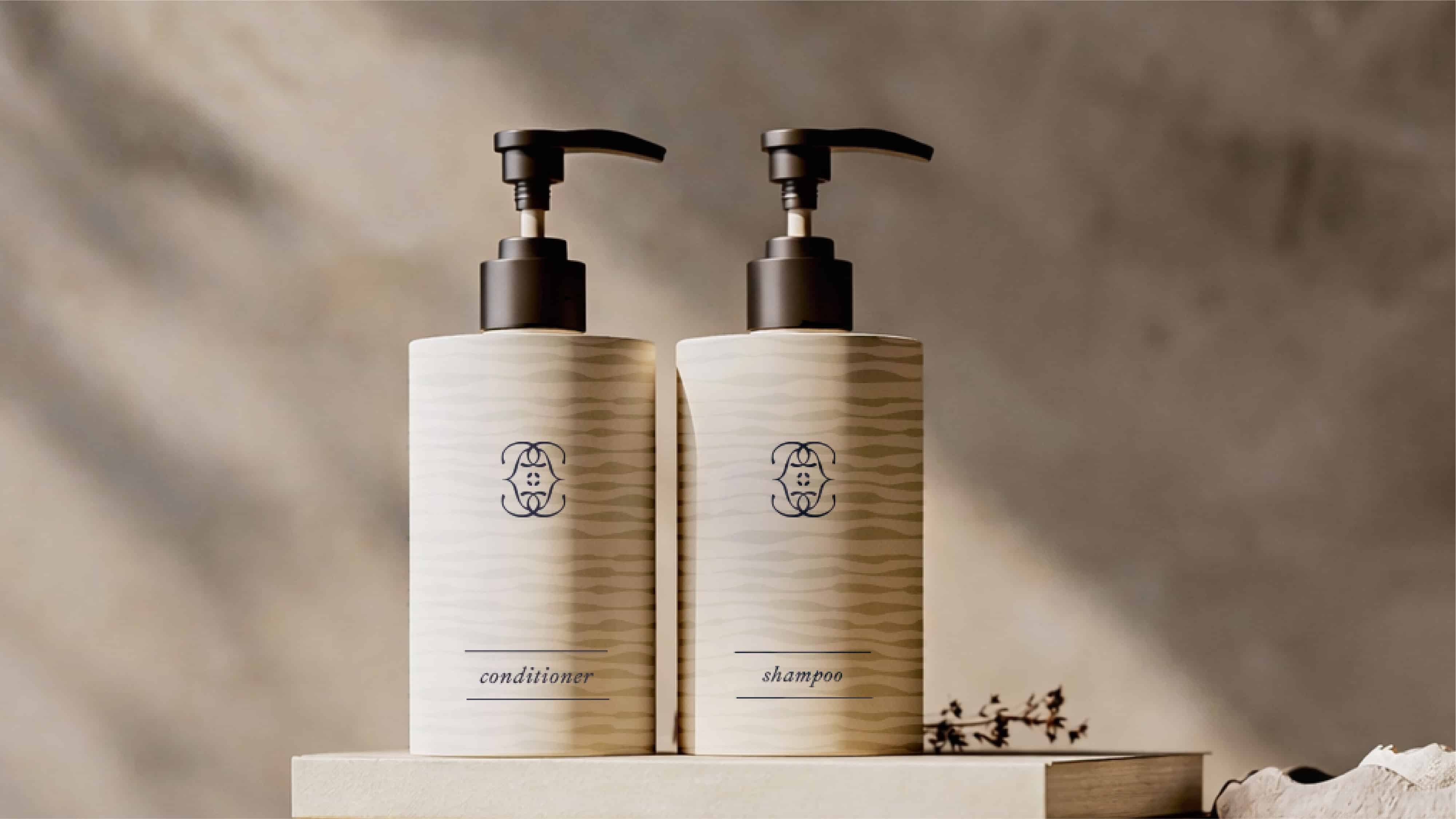 Stylish shampoo and conditioner bottles with pump dispensers for bathroom decor.