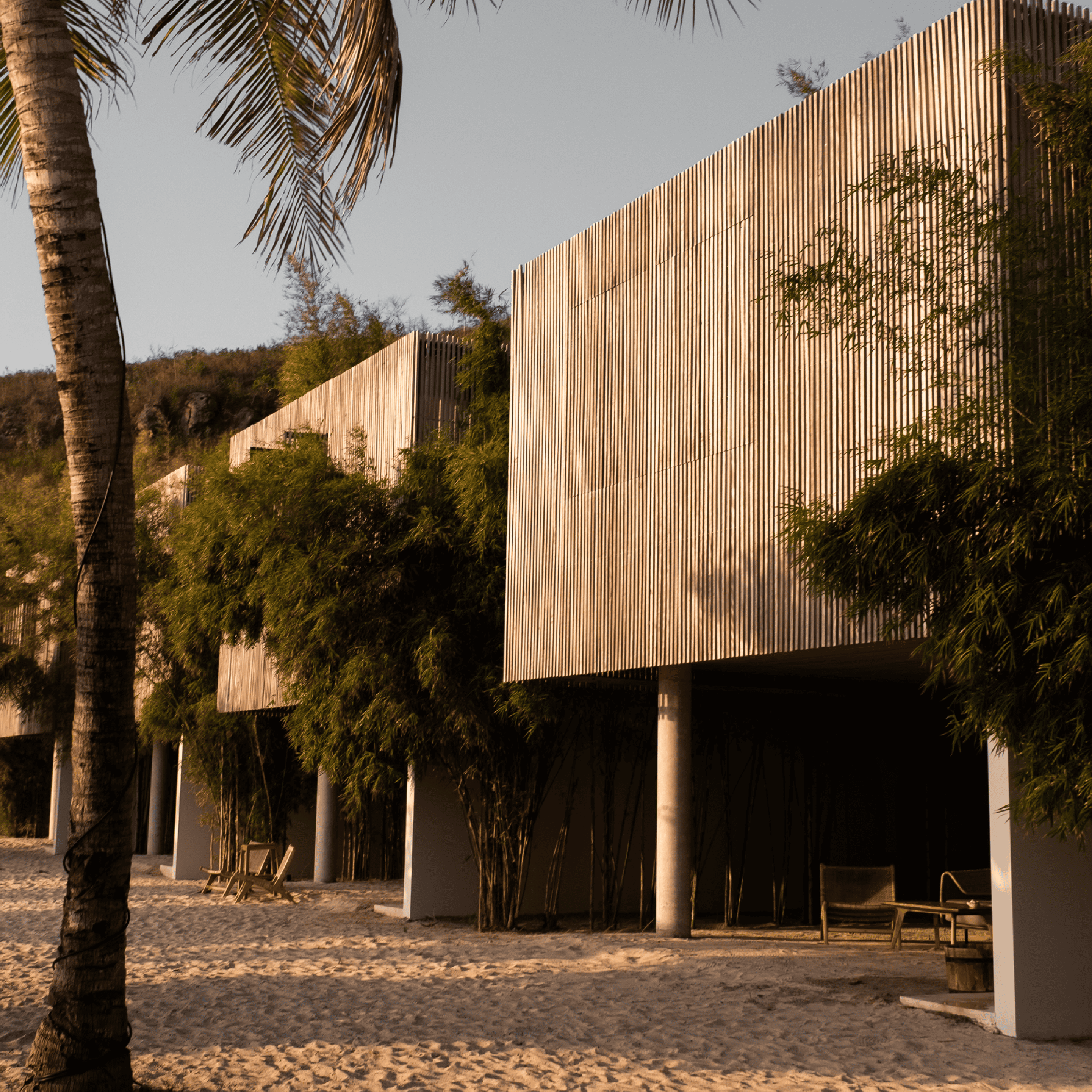 Contemporary beach cabins with wooden facades and lush greenery at Butiq World.