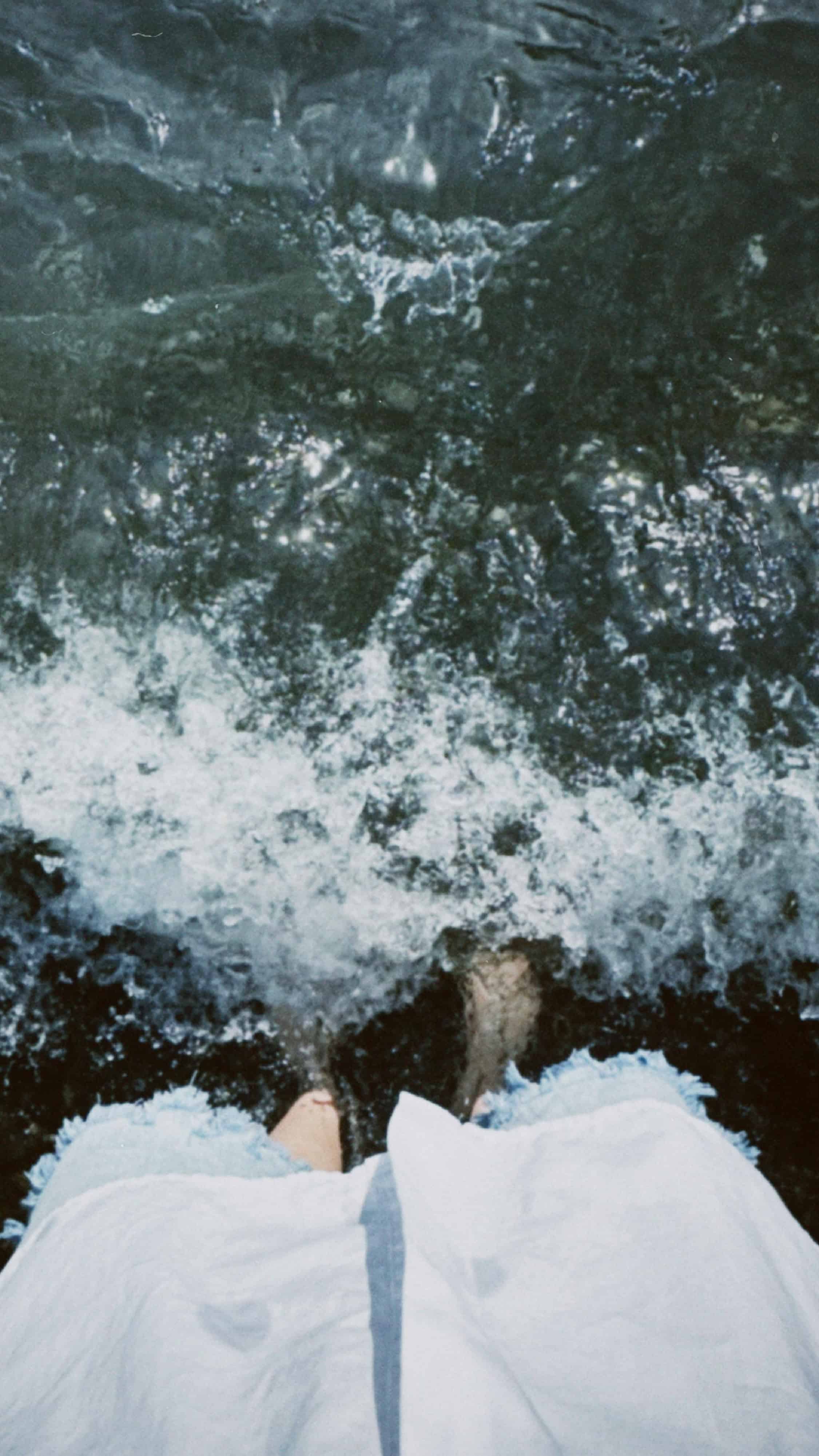 Person standing near water at Palacio del Agua, reflecting tranquility and natural beauty.