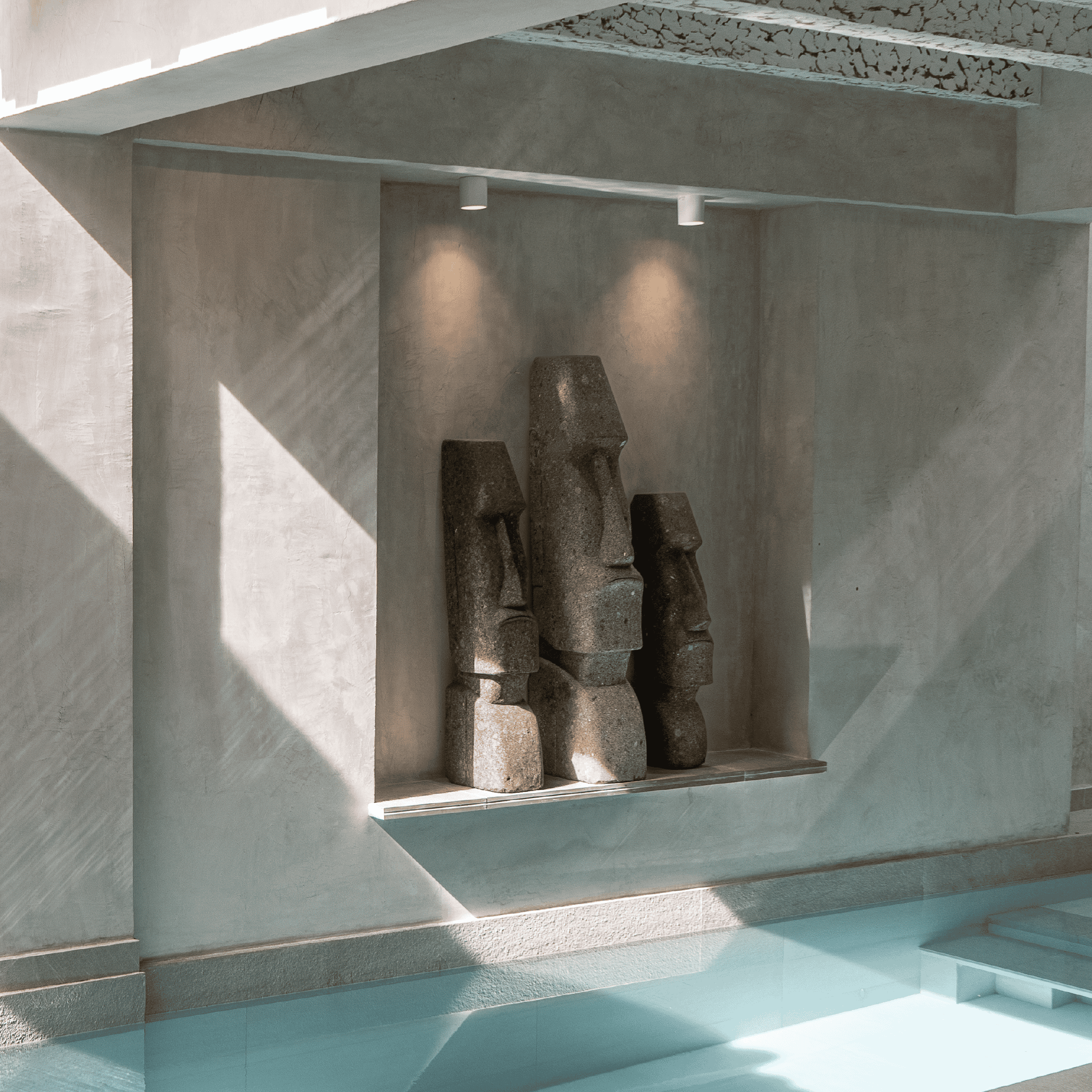 Contemporary concrete sculptures displayed on a shelf at Butiq World.
