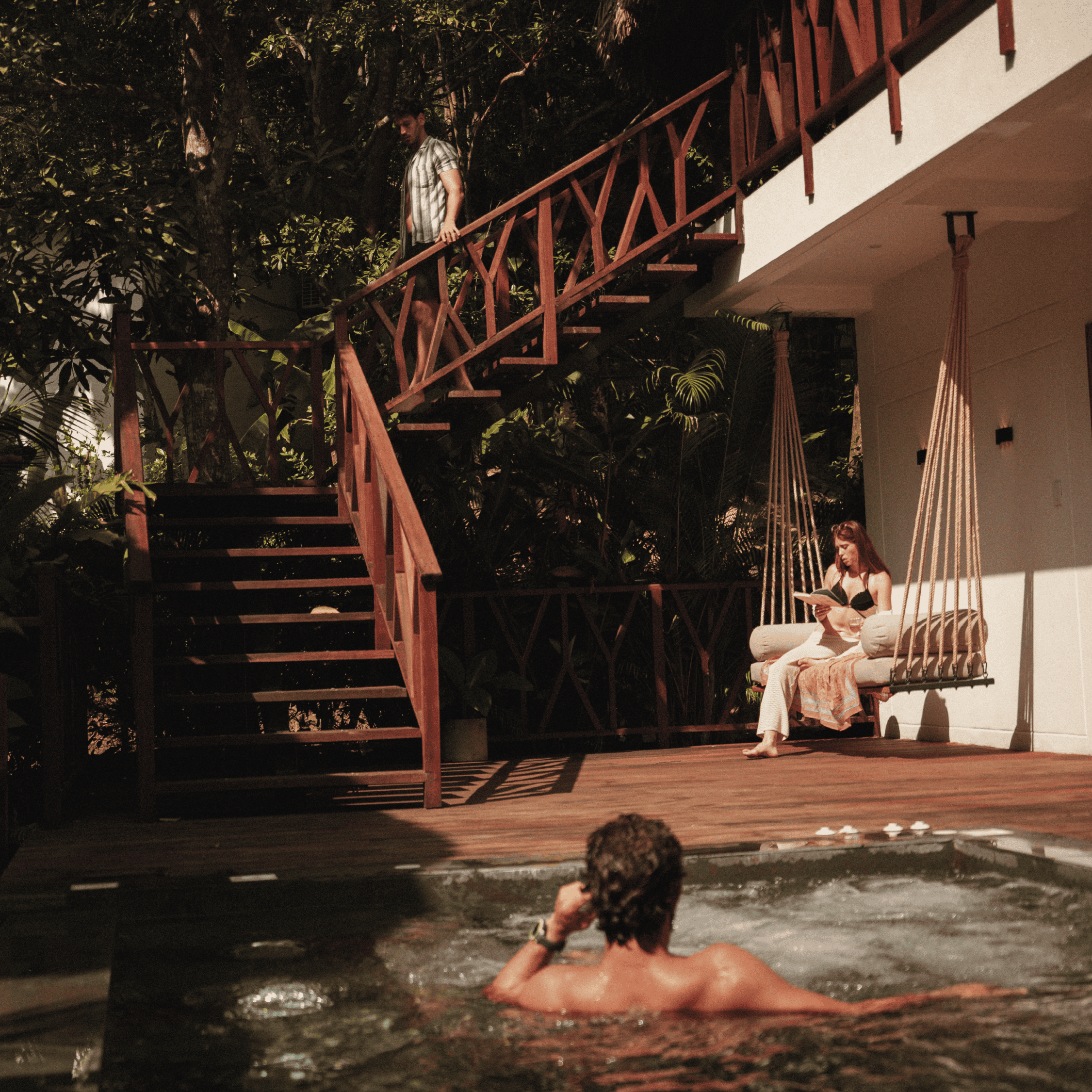 Poolside relaxation at Butiq World with people enjoying sunny weather and outdoor amenities.